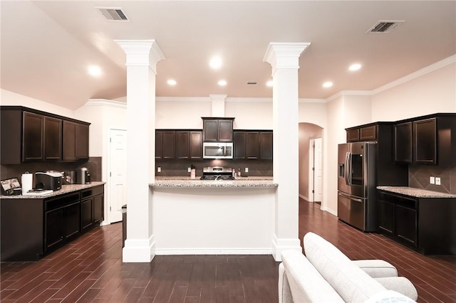 7717 Cattlemen Dr, Corpus Christi, TX 78414 - kitchen with appliances with stainless steel finishes, ornate columns, tasteful backsplash, crown molding, and recessed lighting