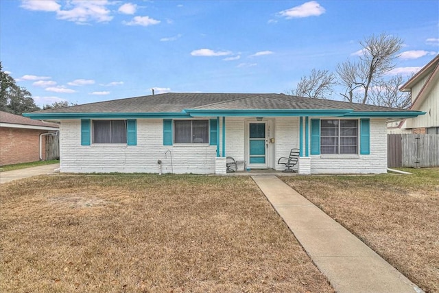 ranch-style house with covered porch and a front lawn