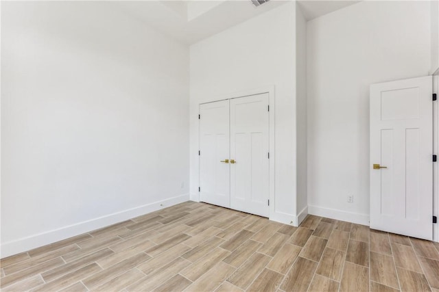 unfurnished bedroom with baseboards, light wood finished floors, and visible vents