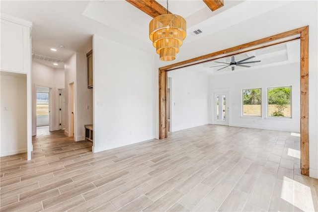 unfurnished living room featuring light wood-style flooring, visible vents, beam ceiling, and ceiling fan with notable chandelier