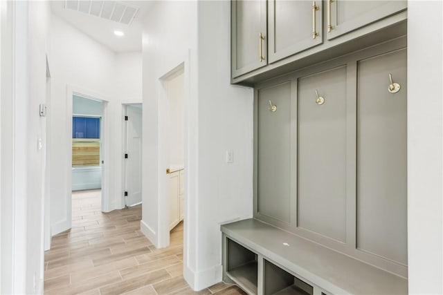 mudroom with visible vents, recessed lighting, light wood finished floors, and baseboards