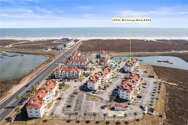 drone / aerial view with a beach view and a water view