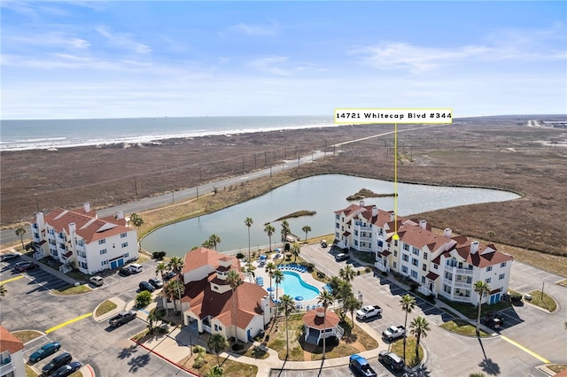 aerial view with a water view and a view of the beach