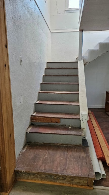 staircase featuring wood finished floors