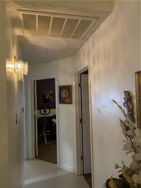 2237 Sunset Cliff Dr, Ingleside, TX 78362 - hallway featuring light tile patterned floors, a chandelier, and baseboards