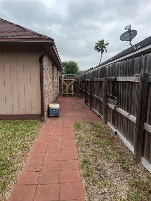 2237 Sunset Cliff Dr, Ingleside, TX 78362 - view of yard with a gate and a patio area