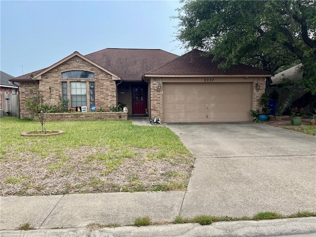2237 Sunset Cliff Dr, Ingleside, TX 78362 - ranch-style house featuring brick siding, an attached garage, a front yard, and concrete driveway