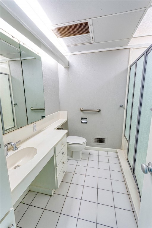 full bathroom with visible vents, toilet, a shower with shower door, tile patterned floors, and vanity