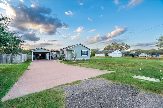 view of front of home featuring a front yard, an outdoor structure, and a garage