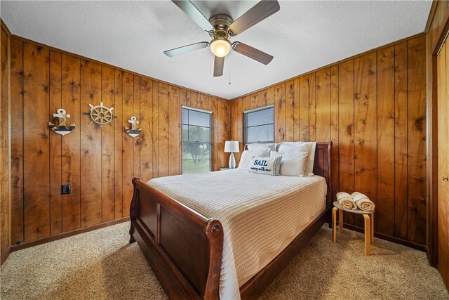 478 S County Road 1144, Riviera, TX 78379 - bedroom with carpet, wood walls, baseboards, ceiling fan, and a textured ceiling
