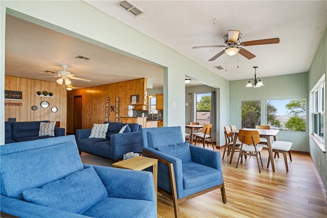 478 S County Road 1144, Riviera, TX 78379 - living area with ceiling fan, wooden walls, light wood finished floors, and a chandelier