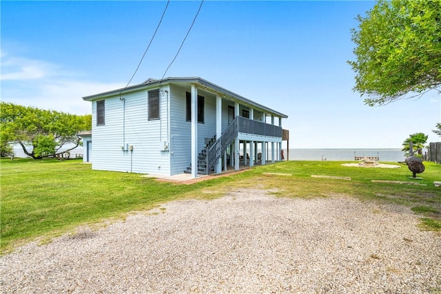 478 S County Road 1144, Riviera, TX 78379 - view of property exterior featuring stairway, a lawn, and a water view