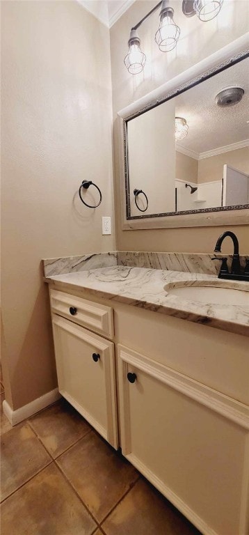 bathroom with tile patterned flooring, vanity, and crown molding