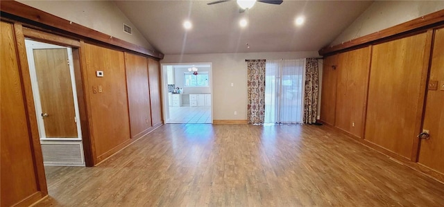 spare room with vaulted ceiling, light hardwood / wood-style flooring, and ceiling fan