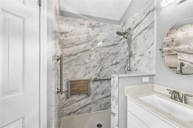 15658 Cumana Dr, Corpus Christi, TX 78418 - bathroom featuring a marble finish shower, vanity, and vaulted ceiling