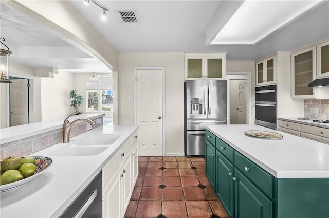 15658 Cumana Dr, Corpus Christi, TX 78418 - kitchen with stainless steel appliances, green cabinets, light countertops, and white cabinetry