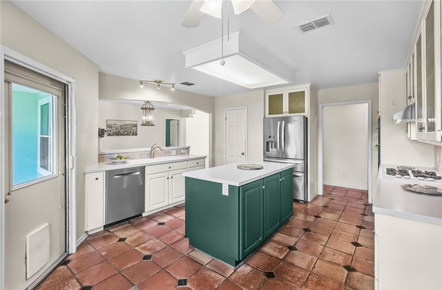 15658 Cumana Dr, Corpus Christi, TX 78418 - kitchen featuring appliances with stainless steel finishes, green cabinetry, under cabinet range hood, a center island, and light countertops