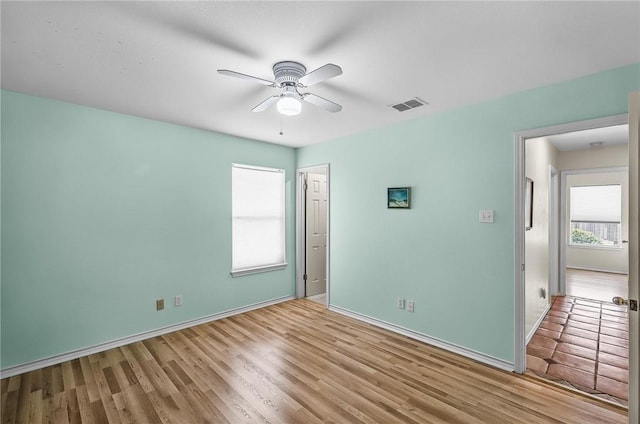 15658 Cumana Dr, Corpus Christi, TX 78418 - unfurnished bedroom featuring multiple windows, wood finished floors, and ceiling fan