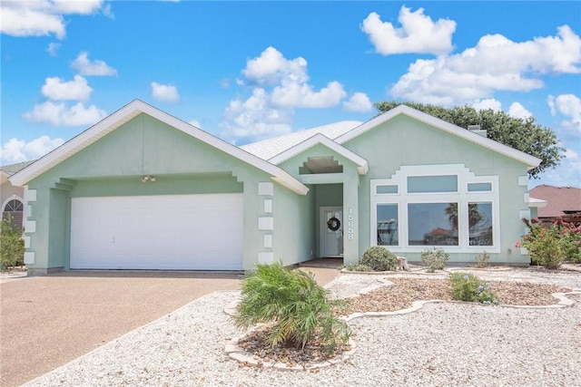 15658 Cumana Dr, Corpus Christi, TX 78418 - ranch-style house featuring an attached garage, driveway, and stucco siding