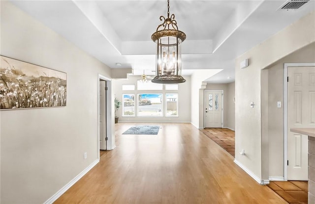 15658 Cumana Dr, Corpus Christi, TX 78418 - hallway featuring a chandelier, wood finished floors, and a raised ceiling