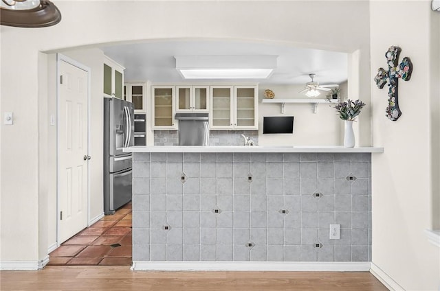 15658 Cumana Dr, Corpus Christi, TX 78418 - kitchen featuring stainless steel refrigerator with ice dispenser, ceiling fan, glass insert cabinets, and wood finished floors