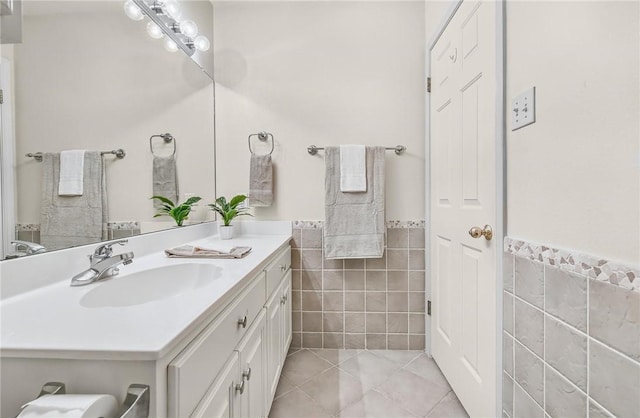 15658 Cumana Dr, Corpus Christi, TX 78418 - bathroom featuring tile walls, tile patterned floors, vanity, and a wainscoted wall