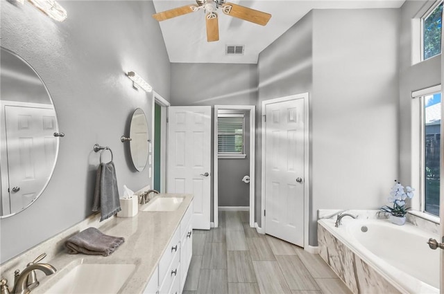 15658 Cumana Dr, Corpus Christi, TX 78418 - bathroom featuring double vanity, a bath, and ceiling fan