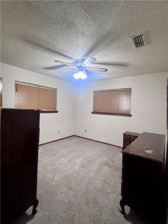 806 Dakota St, Robstown, TX 78380 - unfurnished bedroom with carpet, a textured ceiling, and ceiling fan