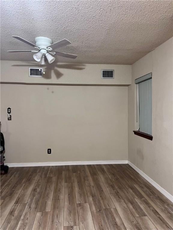 806 Dakota St, Robstown, TX 78380 - empty room featuring a ceiling fan, wood finished floors, and a textured ceiling