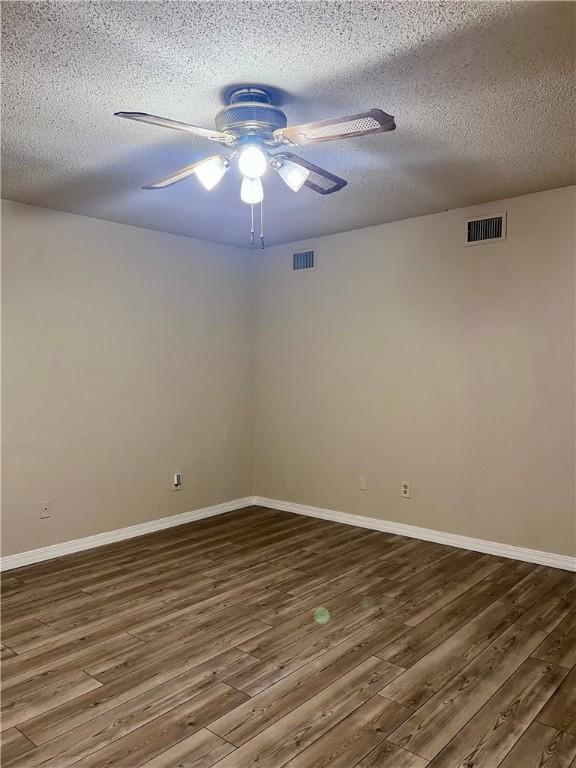 806 Dakota St, Robstown, TX 78380 - spare room featuring ceiling fan, wood finished floors, and a textured ceiling