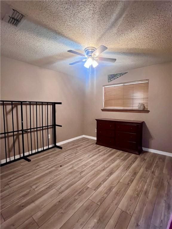 806 Dakota St, Robstown, TX 78380 - unfurnished bedroom with a textured ceiling and wood finished floors