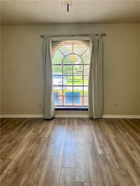 806 Dakota St, Robstown, TX 78380 - unfurnished room with a textured ceiling and wood-type flooring