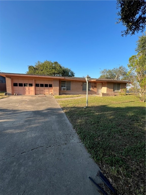 single story home with a garage and a front yard