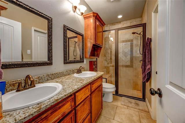 bathroom with walk in shower, vanity, toilet, and tile patterned flooring