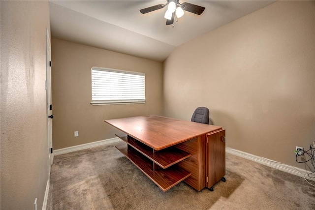 office space featuring carpet floors, ceiling fan, and vaulted ceiling