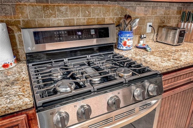 room details with stainless steel gas range oven and light stone counters