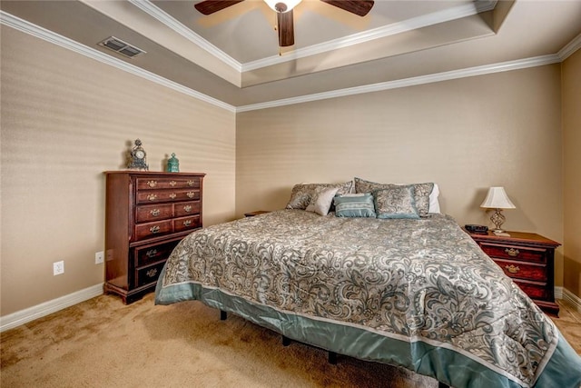 bedroom with ceiling fan, carpet, crown molding, and a tray ceiling