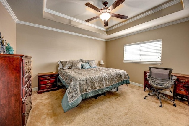 carpeted bedroom featuring ceiling fan, a tray ceiling, and ornamental molding