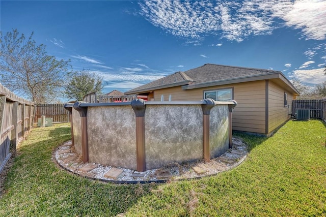 view of home's exterior featuring central AC unit, a swimming pool, and a lawn