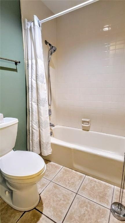 full bathroom featuring tile patterned flooring, shower / bath combination with curtain, and toilet