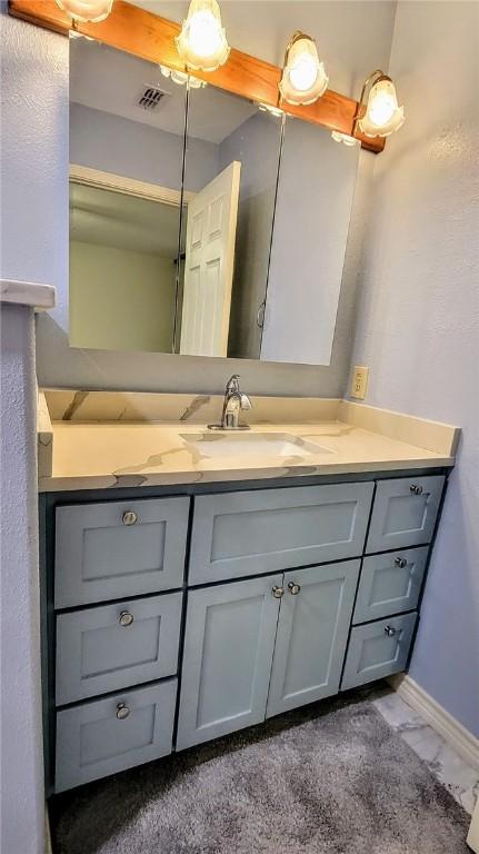 bathroom featuring visible vents, marble finish floor, vanity, and baseboards