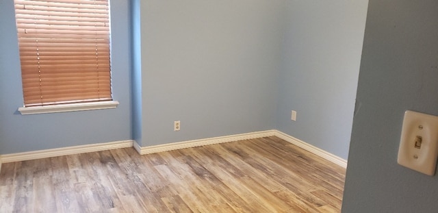 unfurnished room with wood-type flooring