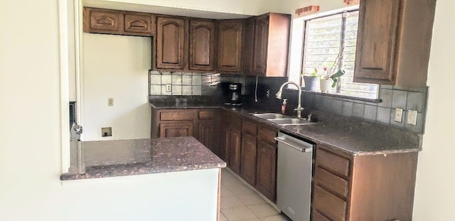 kitchen featuring dishwasher, light tile patterned flooring, sink, and tasteful backsplash