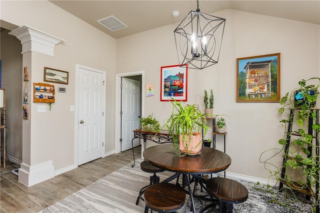 6766 Mikayla St, Corpus Christi, TX 78413 - dining area with wood finished floors, a chandelier, baseboards, and lofted ceiling