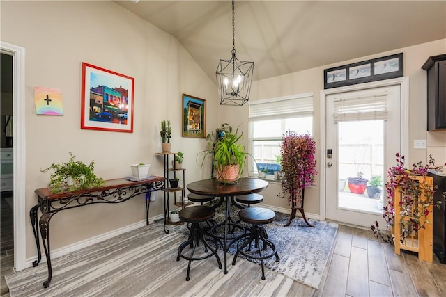 6766 Mikayla St, Corpus Christi, TX 78413 - dining space featuring a chandelier, light wood-type flooring, lofted ceiling, and baseboards