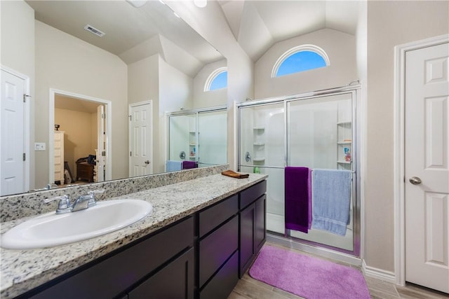 6766 Mikayla St, Corpus Christi, TX 78413 - full bathroom with lofted ceiling, a shower stall, vanity, wood finished floors, and baseboards