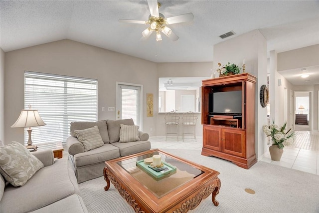 8006 Etienne Dr, Corpus Christi, TX 78414 - living room with a ceiling fan, plenty of natural light, vaulted ceiling, a textured ceiling, and light tile patterned floors