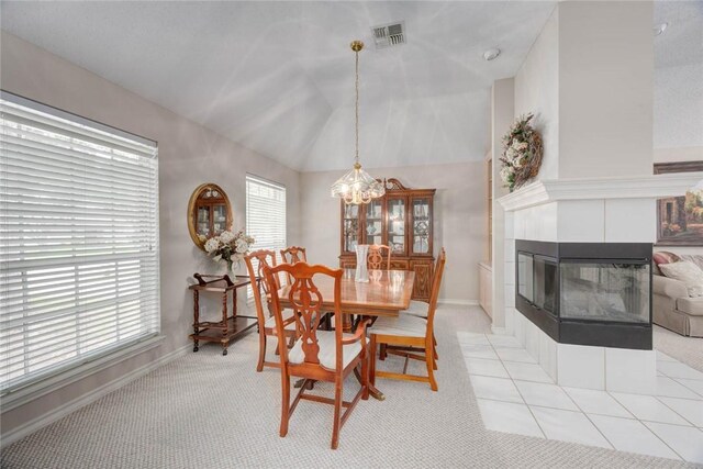 8006 Etienne Dr, Corpus Christi, TX 78414 - dining room with light colored carpet, a chandelier, lofted ceiling, a fireplace, and baseboards