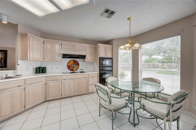 8006 Etienne Dr, Corpus Christi, TX 78414 - kitchen featuring black appliances, under cabinet range hood, a chandelier, light countertops, and light tile patterned flooring