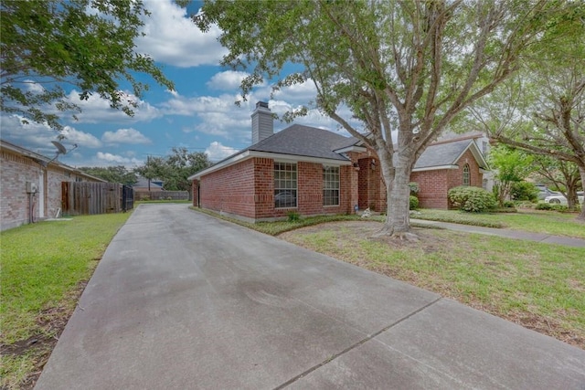 8006 Etienne Dr, Corpus Christi, TX 78414 - view of front of home featuring a chimney, brick siding, and driveway